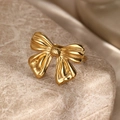 Elegant gold bow-shaped ring with textured silk-like finish on marble surface - Gold Bowknot Style (F3157)