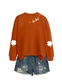 Detail of lucky clover prints on sleeves and script lettering on orange sweatshirt - Burnt Orange (White Font)
