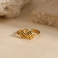 Minimalist double line twisted knot open ring in golden finish on stone background - Gold Knot Style (N6895)