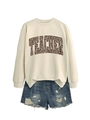 Detail of white teacher sweatshirt with leopard print text and distressed denim shorts - Sand