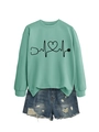 Flat lay of bean green stethoscope heart sweatshirt and frayed blue denim shorts - Light Green (Black Print)