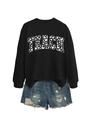 Flat lay of black Teach sweatshirt with heart pattern and distressed blue denim shorts - Black (White Font)