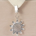 Detailed macro view of a silver sunflower tablecloth weight clip with fine petal carvings - Sunflower Style