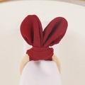 Detail of burgundy fabric bunny ear napkin ring with a natural wooden circle holder - Red Bunny Ear Napkin Ring