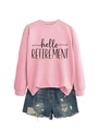 Flat lay of pink Hello Retirement sweatshirt paired with distressed denim shorts - Pink (Black Font)