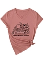 Detail of V-neck T-shirt showing floral book print and stylish front hem knot - Rose Gold (Black Graphic)