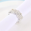Three-row rhinestone beaded napkin ring with silver metal spacers on a white dinner plate - Beaded Napkin Ring