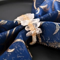 Natural crystal stone napkin ring with gold wire wrap on navy fabric setting - Gold Crystal Stone Style