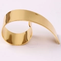 Macro view of gold whistle-shaped napkin ring with polished metallic finish - Gold Whistle Napkin Ring
