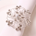 Floral silver napkin ring with hollowed rhinestone design on a white cloth napkin - Silver Rhinestone Flower Napkin Ring
