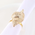 Elegant conch shell napkin ring with gold metallic edges on a white cloth napkin - Conch Style / Gold