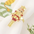 Detail of Nutcracker soldier napkin ring with gold finish and red glitter on white napkin - Red Glitter Soldier Style (Style 9)