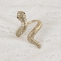 Exaggerated vintage gold snake napkin ring with scale texture on lace fabric background - Antique Gold Snake Napkin Ring