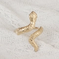 Macro detail of golden snake napkin ring showing textured scales and artistic animal design - Gold Snake Napkin Ring