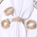 Set of four gold braided rope napkin rings on a white plate with white napkin decor - Off White