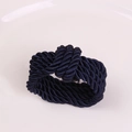 Detailed close-up of dark blue woven rope knot design for napkins and table decor - Navy Blue