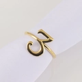 Macro shot of gold napkin ring featuring Arabic calligraphy on a white fabric napkin - Number 3 / Gold