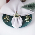 Detailed view of three gold Christmas tree napkin rings with green and white enamel finish - Christmas Tree