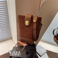 Retro dark brown bucket bag in matte suede and leather with gold clasp and shoulder strap - Brown