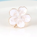 Macro detail of plum blossom napkin ring with white enamel petals and gold veins - Napkin Ring / White