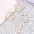 Set of four geometric gold metal napkin rings in triangle, square, pentagon and circle shapes - Set of 4 Geometric Shapes