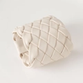 Macro detail of the woven cream PU leather napkin ring with intricate texture - White