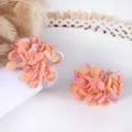 Pink handmade sequin flower napkin rings set on a white ceramic plate for table decor - Coral Orange