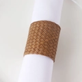 Close-up of brown PU leather woven napkin ring on a white napkin for table decor - Brown