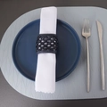 Macro view of navy blue woven PU leather napkin ring on a table setting - Black