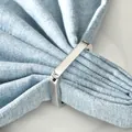 Modern silver polished square metal napkin ring with elegant light blue fabric on white desk - Silver