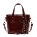 Burgundy bucket bag with metallic rivets and stylish charms on a white background - With Pendant / Ancorra Red