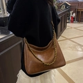 Dark brown hobo shoulder bag with a polished finish and elegant gold chain strap - Tan