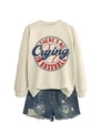 Detail of white sweatshirt with red baseball slogan print and distressed denim shorts - Sand