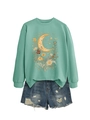 Detail of mint green sweatshirt with floral moon print and distressed denim shorts - Light Green