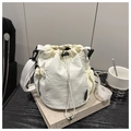 Detail of off-white drawstring bucket bag made of textured water-repellent nylon material - White