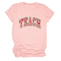 Close-up of pink cotton T-shirt featuring TEACH text with red strawberry pattern fill - Pink
