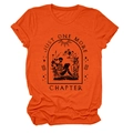 Close-up of orange t-shirt featuring gothic skull reading a book and text Just One More Chapter - Orange (Black Text)