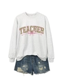 Close-up of TEACHER sweatshirt with clover patterns and a pink bow on gray fabric - Off-White