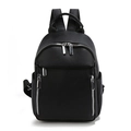 Minimalist black pebble leather backpack for women with silver zippers on white background - Black