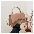 Detail of light khaki box bag with gold chain and asymmetric flap held by a model - Khaki