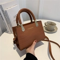 Brown crocodile embossed handbag with woven handle and adjustable crossbody strap - Brown