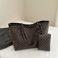 Brown monogram tote bag set with matching pouch on textured white surface - Brown