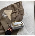 Silver metallic hard-shell clutch with gold handle and chain on a brown blazer - Silver