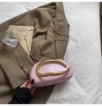 Light pink evening bag with gold metal handle and chain strap on stylish background - Pink