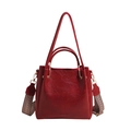 Red leather bucket bag with decorative geometric woven shoulder strap and top handle - Red