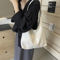 Minimalist cream-colored oil wax leather tote bag shown on model for daily commuting - Off White