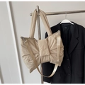 Detail of beige puffer tote bag with ribbon design and adjustable woven shoulder strap - Khaki
