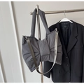 Detail of grey nylon bow bag with adjustable shoulder strap and wide top handle - Gray