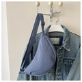 Detailed close-up of grey-blue crescent nylon bag with adjustable strap on white hanger - Blue