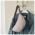 Detail of light purple crescent crossbody bag with adjustable wide fabric strap - Gray
